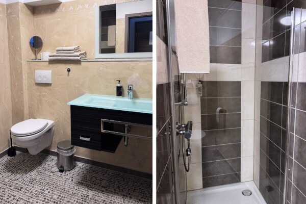 Ein hochwertiges Badezimmer in zwei Perspektiven: Der Waschtischbereich zeigt cremefarbene Marmorfliesen, einen eleganten dunklen Holz-Waschtisch mit hellblauer Glasplatte und doppelten modernen Spiegeln. Die Duschzone präsentiert eine bodengleiche, ebenerdige Dusche mit graubraunen und weißen Fliesen, einer großflächigen Glastür und moderner Handbrause. Der minimalistischen Gestaltung, Kombination aus warmen und kühlen Tönen sowie der modernen Ausrüstung verleihen dem Raum eine luxuriöse, entspannende Wellness-Atmosphäre. Ein hochwertiges Badezimmer in zwei Perspektiven: Der Waschtischbereich zeigt cremefarbene Marmorfliesen, einen eleganten dunklen Holz-Waschtisch mit hellblauer Glasplatte und doppelten modernen Spiegeln. Die Duschzone präsentiert eine bodengleiche, ebenerdige Dusche mit graubraunen und weißen Fliesen, einer großflächigen Glastür und moderner Handbrause. Der minimalistischen Gestaltung, Kombination aus warmen und kühlen Tönen sowie der modernen Ausrüstung verleihen dem Raum eine luxuriöse, entspannende Wellness-Atmosphäre.